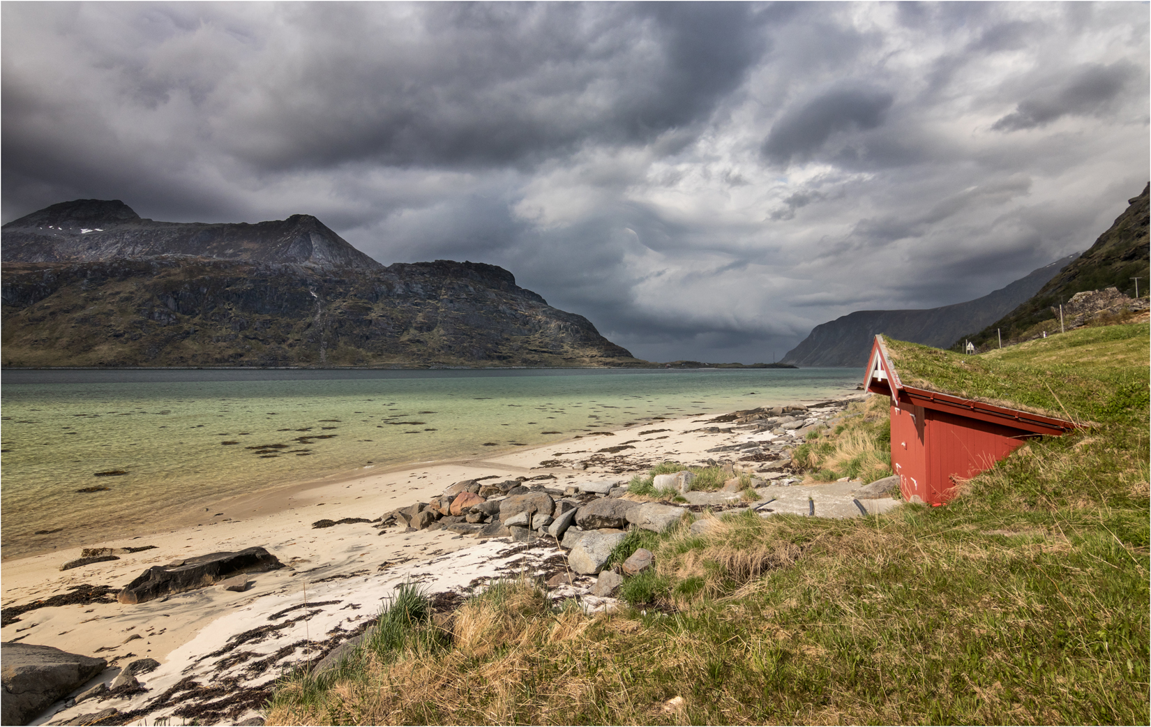 A Small Red Hut On The Flakstadpollen